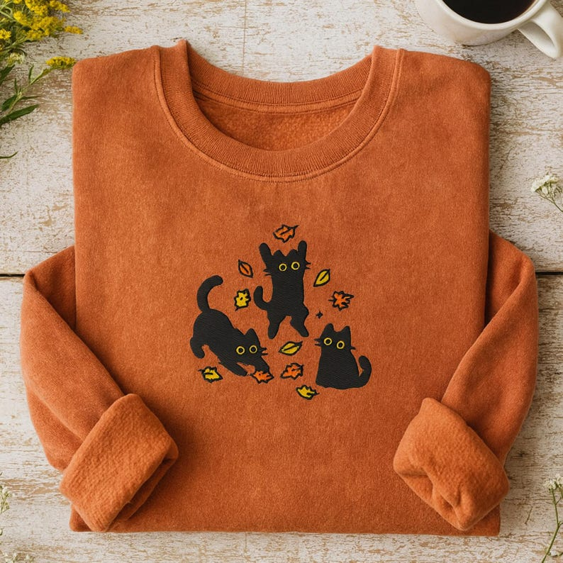 EMBROIDERED Cute Black Cat Pouncing Leaves Sweatshirt, Cozy Cat Lover Sweatshirt, Autumn Vibes Tee, Cozy Fall Halloween Embroidered Shirt